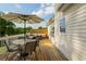 Spacious deck with an umbrella-covered dining table and comfortable outdoor seating, perfect for entertaining at 780 Old Magnolia Trl, Canton, GA 30115