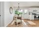 Cozy dining area with hardwood floors, bright windows, and modern appliances is perfect for meals and gatherings at 780 Old Magnolia Trl, Canton, GA 30115
