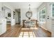 Sunlit dining area with hardwood floors, large windows, and stylish chandelier offers a delightful dining experience at 780 Old Magnolia Trl, Canton, GA 30115