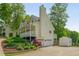 Charming two-story home with a white porch, well-manicured lawn, attached garage and shed at 780 Old Magnolia Trl, Canton, GA 30115