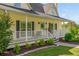 Inviting front porch with white railing, black shutters, and tasteful landscaping at 780 Old Magnolia Trl, Canton, GA 30115