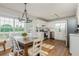 Open kitchen with stainless steel appliances, white cabinetry, wood floors, and bright breakfast area at 780 Old Magnolia Trl, Canton, GA 30115
