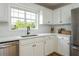 Bright kitchen features white cabinets, stainless steel appliances, and a subway tile backsplash at 780 Old Magnolia Trl, Canton, GA 30115