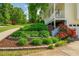 Beautifully landscaped with lush greenery, stone borders, and colorful blooming flowers at 780 Old Magnolia Trl, Canton, GA 30115