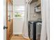 Convenient laundry room features modern washer and dryer, wood door, and natural light at 780 Old Magnolia Trl, Canton, GA 30115