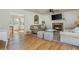 Open-concept living room with a fireplace, hardwood floors, and bright natural light enhances the space at 780 Old Magnolia Trl, Canton, GA 30115