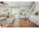 Spacious living room with hardwood floors, white walls, large windows, and staircase provides comfort at 780 Old Magnolia Trl, Canton, GA 30115