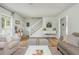 Bright and airy living room with hardwood floors, staircase, white walls and neutral furnishings at 780 Old Magnolia Trl, Canton, GA 30115