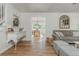 Bright living room with hardwood floors leads to the dining area creates a comfortable and stylish living space at 780 Old Magnolia Trl, Canton, GA 30115