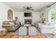 Cozy living room featuring a fireplace, ceiling fan, neutral decor, hardwood floors and ample seating at 780 Old Magnolia Trl, Canton, GA 30115