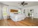 Bright main bedroom features wooden floors, stylish headboard, and access to a modern ensuite bathroom at 780 Old Magnolia Trl, Canton, GA 30115