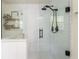 Beautiful shower features white subway tiles, black trim, glass surround, and rainfall shower head at 780 Old Magnolia Trl, Canton, GA 30115