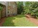 Spacious backyard featuring a well-maintained lawn and mature trees, perfect for outdoor activities at 1632 Brookhaven Close Ne, Atlanta, GA 30319