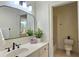 Bright bathroom with a large framed mirror, white cabinets, and a view to the shower at 1632 Brookhaven Close Ne, Atlanta, GA 30319