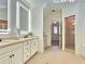 Bathroom featuring double sink vanity, modern lighting, and walk-in shower at 1632 Brookhaven Close Ne, Atlanta, GA 30319