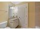 Bathroom with granite vanity, tile floors, and a decorative wall mirror at 1632 Brookhaven Close Ne, Atlanta, GA 30319