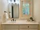 Neutral bathroom with a framed mirror and a white vanity with drawers and knobs at 1632 Brookhaven Close Ne, Atlanta, GA 30319