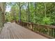 Expansive wooden deck provides ample space for relaxation and outdoor living amidst a serene wooded setting at 1632 Brookhaven Close Ne, Atlanta, GA 30319