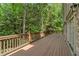 Large wooden deck overlooks a beautifully wooded backyard, ideal for outdoor entertaining at 1632 Brookhaven Close Ne, Atlanta, GA 30319