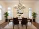 Staged dining room featuring modern chandelier, decorative rug, and hardwood floors at 1632 Brookhaven Close Ne, Atlanta, GA 30319
