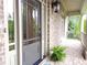 Brick porch with brick front and side pillars and a gray front door at 1632 Brookhaven Close Ne, Atlanta, GA 30319