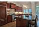 Gourmet kitchen with stainless steel appliances, dark wood cabinets, and granite countertops at 1632 Brookhaven Close Ne, Atlanta, GA 30319