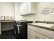Laundry room featuring modern washer and dryer, sink, countertop space, and cabinets at 1632 Brookhaven Close Ne, Atlanta, GA 30319