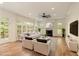Staged living room with a fireplace, hardwood floors, and large windows at 1632 Brookhaven Close Ne, Atlanta, GA 30319