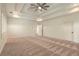 Spacious bedroom featuring tray ceiling, neutral carpet, and two doors at 1632 Brookhaven Close Ne, Atlanta, GA 30319
