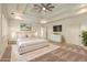 Staged main bedroom with tray ceiling, white furniture, and a plush rug at 1632 Brookhaven Close Ne, Atlanta, GA 30319