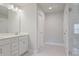 Bright bathroom featuring a double vanity, white cabinetry, and a glass-enclosed shower at 354 Hayden Cir, Woodstock, GA 30189