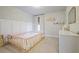 Charming bedroom featuring paneled walls, soft lighting, and neutral carpet at 354 Hayden Cir, Woodstock, GA 30189