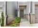 View of the home's entryway, showing the front door and adjacent landscaping, and brickwork at 354 Hayden Cir, Woodstock, GA 30189