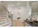 Entryway view displaying hardwood floors, a staircase with metal railing, and decorative furnishings with neutral wall paint at 354 Hayden Cir, Woodstock, GA 30189