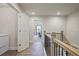 Upstairs hallway featuring wood floors, and views to a bedroom and laundry room, creating a seamless flow at 354 Hayden Cir, Woodstock, GA 30189
