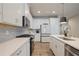 This kitchen boasts white countertops, stainless steel appliances, decorative backsplash, and ample cabinet space at 354 Hayden Cir, Woodstock, GA 30189
