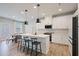Bright eat-in kitchen featuring a large island with bar seating, modern stainless appliances, and white cabinets at 354 Hayden Cir, Woodstock, GA 30189