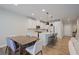 Modern kitchen with white cabinets, stainless appliances, and a center island with bar stool seating next to a dining table at 354 Hayden Cir, Woodstock, GA 30189