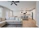 Open-concept design combining living area with white kitchen, island seating, dining table and modern pendant lighting at 354 Hayden Cir, Woodstock, GA 30189