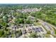 Aerial view of property and neighborhood with mature trees and water tower at 55 Sudderth St, Buford, GA 30518