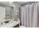 Bathroom featuring a shower with a curtain, a mirror, and granite countertops at 55 Sudderth St, Buford, GA 30518