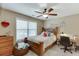Cozy bedroom featuring a charming wooden bedframe, a desk, and a window at 55 Sudderth St, Buford, GA 30518