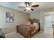 Bedroom featuring carpet, ceiling fan, neutral paint, and a wooden bedframe at 55 Sudderth St, Buford, GA 30518