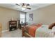 Neutral bedroom with natural light, ceiling fan, carpet, and a workspace by the window at 55 Sudderth St, Buford, GA 30518