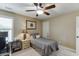 Neutral toned bedroom features a ceiling fan, desk and neutral decor at 55 Sudderth St, Buford, GA 30518