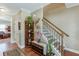 Inviting entryway with hardwood floors, staircase with a detailed iron railing, and a decorative shelf at 55 Sudderth St, Buford, GA 30518