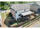 Aerial view of a home with a covered deck, backyard and tiered landscaping at 55 Sudderth St, Buford, GA 30518