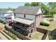Aerial view of a home with a covered deck and a fenced backyard at 55 Sudderth St, Buford, GA 30518