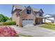 Brick-clad home with attached garage, long driveway, and well-manicured lawn at 55 Sudderth St, Buford, GA 30518