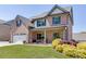 Inviting brick home with a lush front yard and colorful landscaping at 55 Sudderth St, Buford, GA 30518